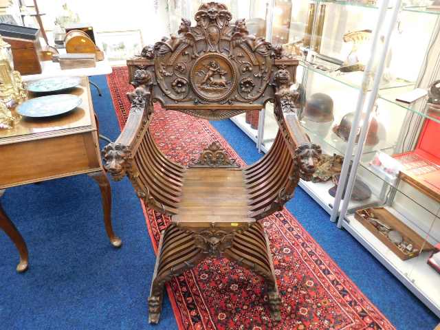 A carved Italian walnut Savonarola folding chair SOLD £400