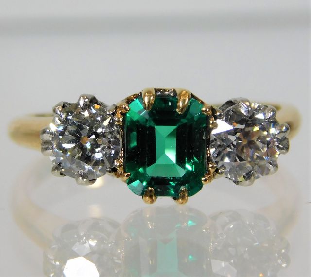 An 18ct gold ring set with approx. 1ct diamond emerald SOLD £1450