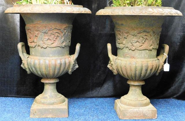 A pair of decorative cast iron urns SOLD £300