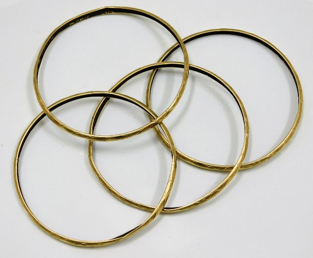 A set of four yellow metal bangles af test as 18ct gold SOLD £700