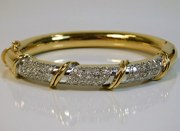 An 18ct gold bangle set with approx. 3ct of small diamonds 30.9g SOLD £1500