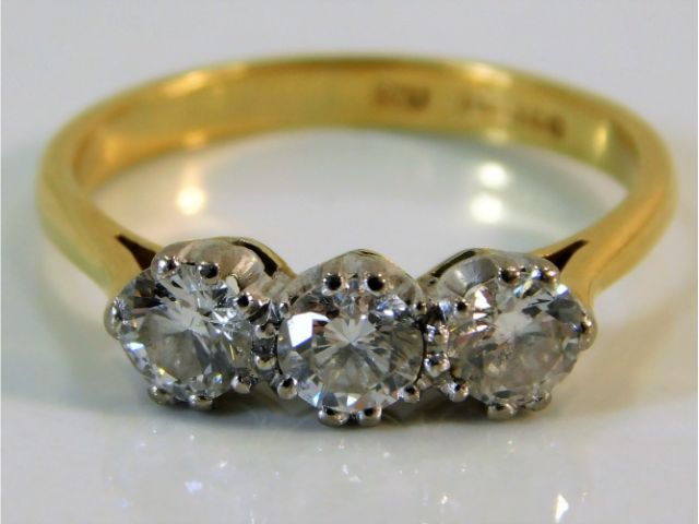 An 18ct gold trilogy ring set with approx. 1ct diamond size MN 3g SOLD £800